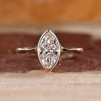 Marquise cut diamond engagement ring made with yellow gold.
