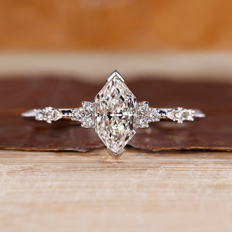 Dutch marquise diamond engagement ring with round cut side stone.