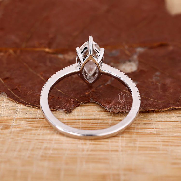 Handmade jewelry ring with lab grown diamond in white gold band.