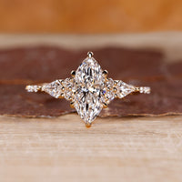 Marquise engagement ring with muse setting and kite side diamonds in yellow gold.