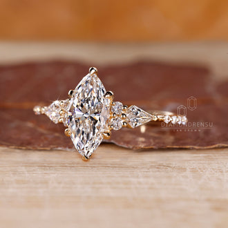 Tapered shank ring with marquise diamond and six claw prong setting.