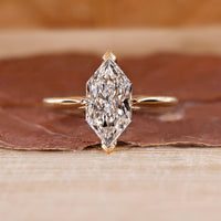 Dutch Marquise Engagement Ring with a round diamond and cathedral setting in yellow gold.