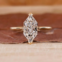 Dutch Marquise Engagement Ring with a round diamond and cathedral setting in yellow gold.