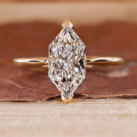 Dutch Marquise Engagement Ring with a round diamond and cathedral setting in yellow gold.