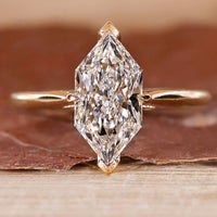 Dutch Marquise Engagement Ring with a round diamond and cathedral setting in yellow gold.