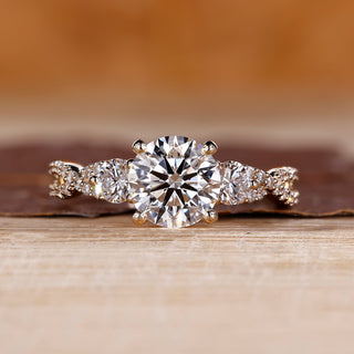 Round cut diamond engagement ring with twisted shank and pave setting.