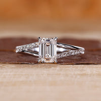 Emerald shape engagement ring with split shank.