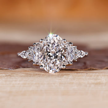 Oval cut diamond engagement ring with muse setting and marquise side stones.