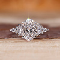 Oval cut diamond engagement ring with muse setting and marquise side stones.