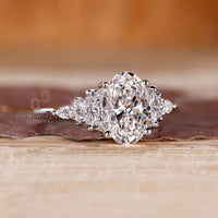 IGI certified oval cut engagement ring with marquise and round side stones.