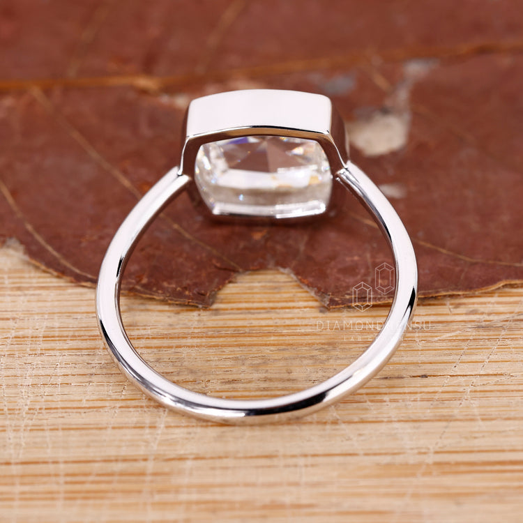 Handmade jewelry with a bezel set lab grown diamond centerpiece.