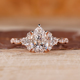 Pear cut engagement ring with muse setting in rose gold.