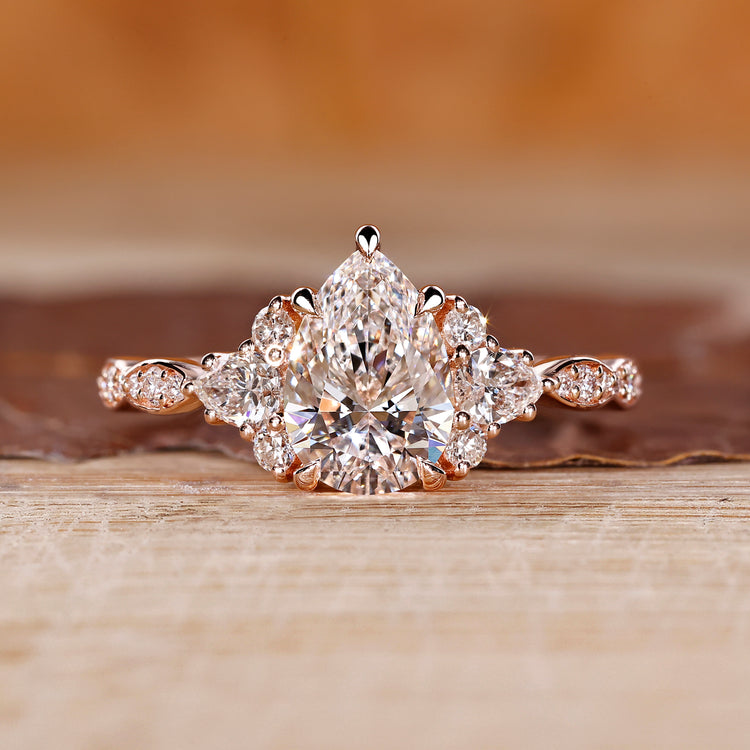 Pear cut engagement ring with muse setting in rose gold.
