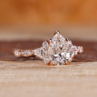 Custom engagement ring with pear cut and side stones.