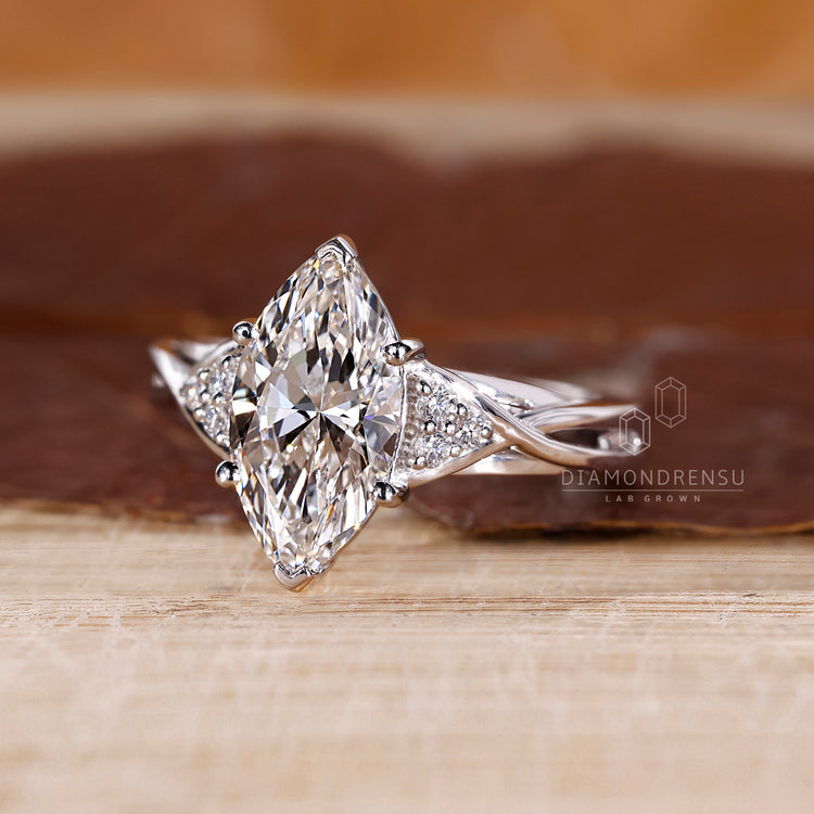 Cathedral setting ring with marquise cut diamond and white gold band.