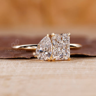 Custom engagement ring featuring a Toi Et Moi design with radiant and pear cuts.