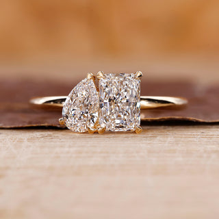 Toi Et Moi Diamond Ring with radiant cut and pear cut diamonds in yellow gold.