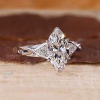 White gold ring with marquise cut diamond in v shaped prong.