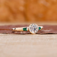 Emerald ring with a bold center stone and handcrafted detailing for a luxe feel.
