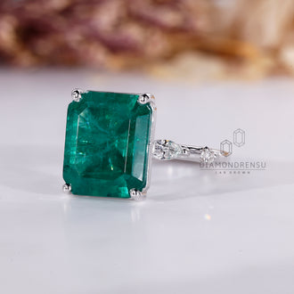 Custom emerald and diamond engagement ring.