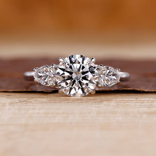 Three stone diamond ring with two pear side stones in white gold.
