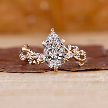 Pear shaped diamond engagement ring in a floral design setting.