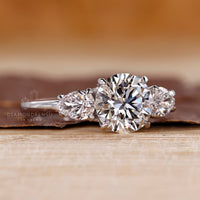 IGI certified white gold engagement ring with pear side stones.