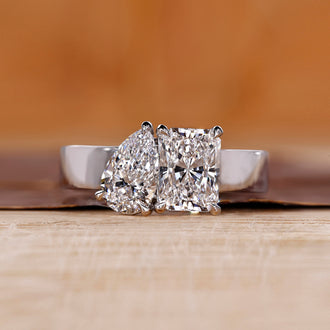 Toi et Moi ring featuring pear and radiant diamonds in white gold.