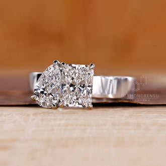 White gold engagement ring with pear and radiant diamond stones.