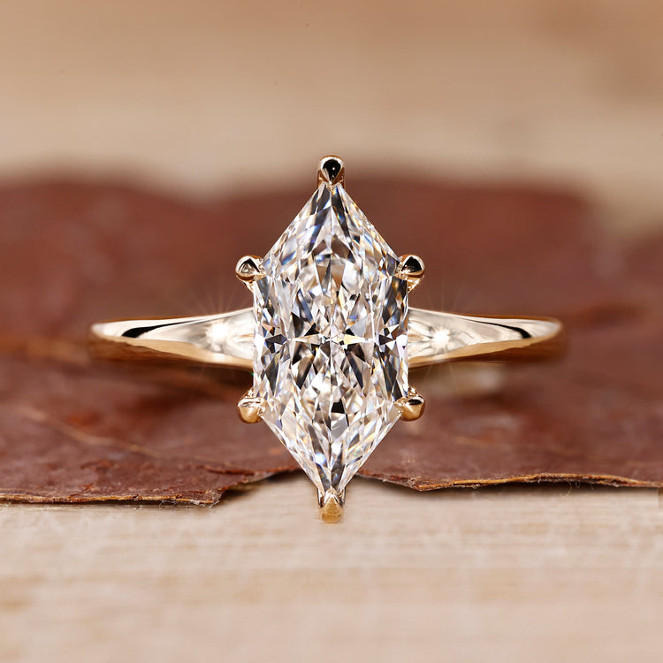 Dutch marquise ring with solitaire setting and yellow gold engagement ring featuring a 6 claw prong.
