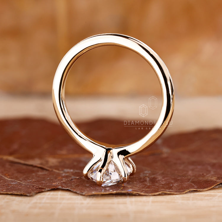 Handmade jewelry featuring a marquise diamond in a solitaire setting with 6 claw prong on a yellow gold engagement ring.