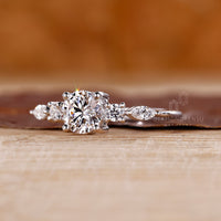 Round and marquise diamond ring with 4 claw prong setting.