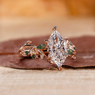 Rose gold engagement ring featuring moss agate and marquise accents.