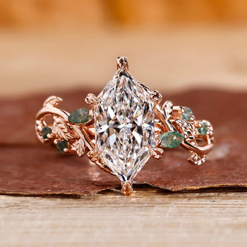 Nature-inspired marquise engagement ring with leaf-style pave design.