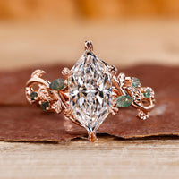 Nature-inspired marquise engagement ring with leaf-style pave design.