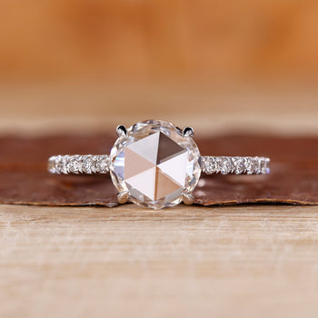 Rose cut engagement ring featuring round rose cut diamond in white gold.