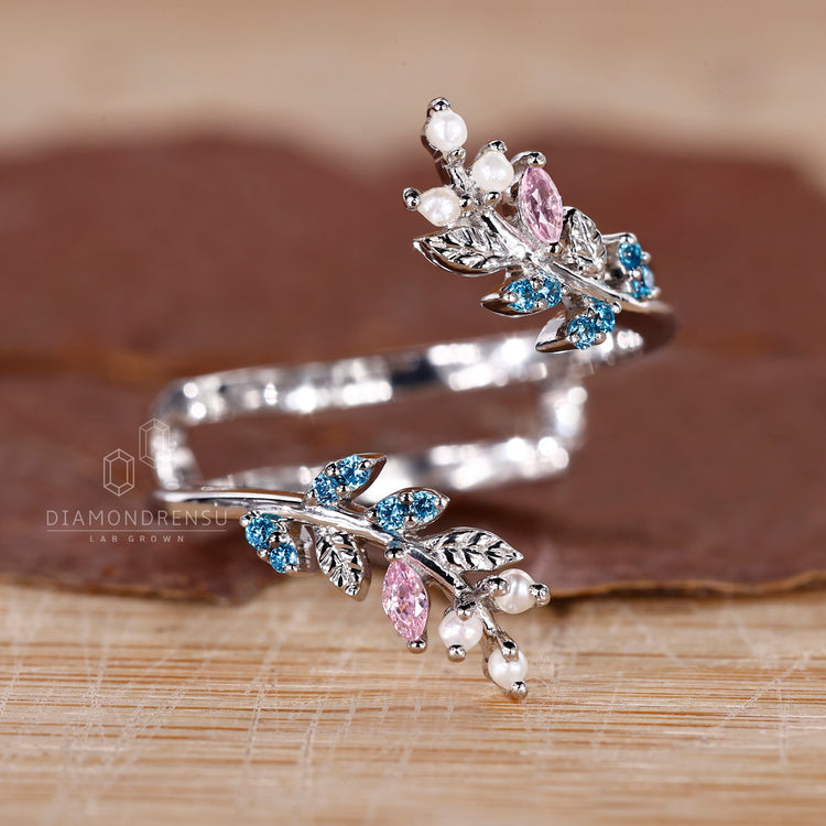 Pink sapphire and aqua sapphire stone on handmade jewelry band.