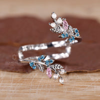 Pink sapphire and aqua sapphire stone on handmade jewelry band.