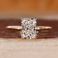 Radiant cut engagement ring featuring solitaire setting and hidden halo diamond.