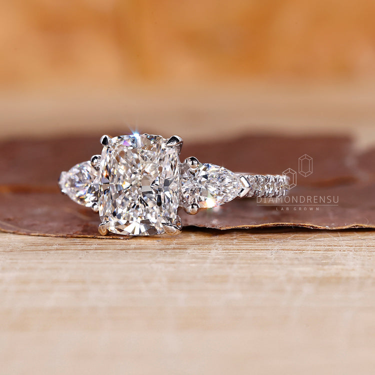 Hidden halo setting surrounds the center stone in a cushion cut ring.