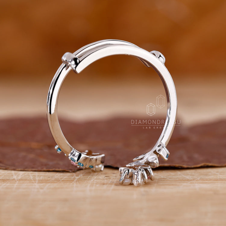 Pink sapphire stone on white gold gemstone wedding band.