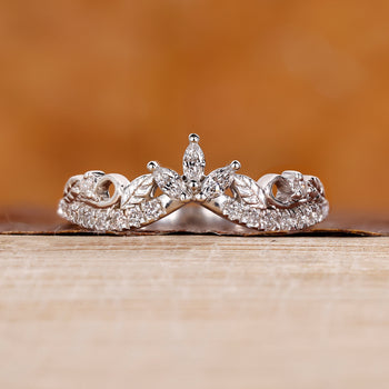Round diamond wedding band in white gold with prong setting.