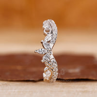 Chevron wedding band with prong set round diamonds in white gold.