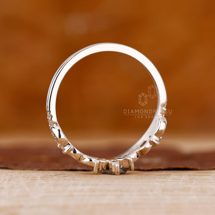 Prong set wedding band with round and marquise diamonds for anniversary.