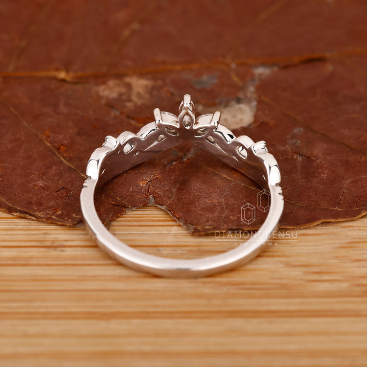 Custom handmade jewelry featuring round and marquise diamond wedding band.