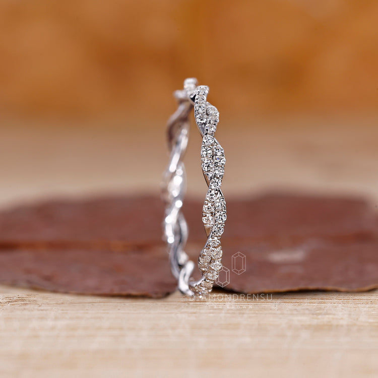 White gold wedding band with round diamonds in a twisted full eternity style.