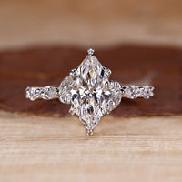 Marquise cut diamond ring in white gold with nature inspired design.