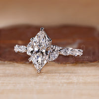 Pave setting ring with marquise cut diamonds in white gold.