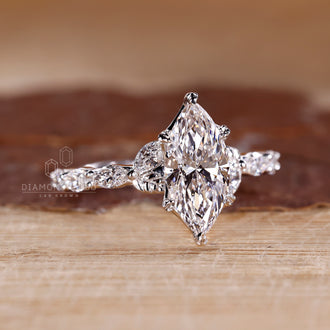 White gold engagement ring with marquise cut diamond and custom design.