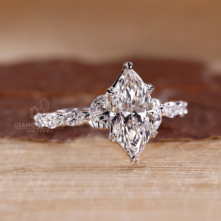 White gold engagement ring with marquise cut diamond and custom design.